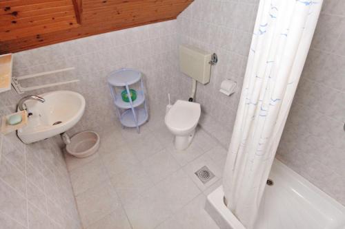 a small bathroom with a toilet and a sink at Apartment Vrsi - Mulo 5796a in Vrsi