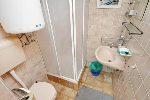 a bathroom with a shower and a toilet and a sink at Apartments and rooms by the sea Nin, Zadar - 5858 in Nin