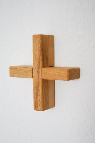 a wooden cross hanging on a white wall at Hotel Haus vom Guten Hirten in Münster