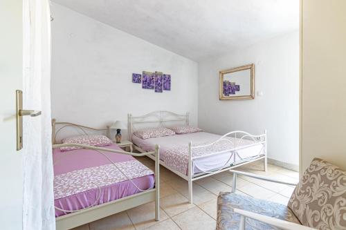 a room with two beds and a chair at Apartments by the sea Cove Pokrivenik, Hvar - 4604 in Gdinj