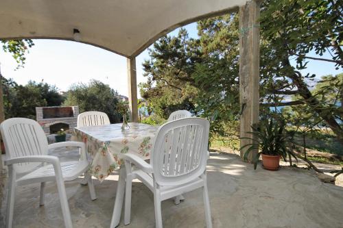 a white table and chairs on a patio at Apartments by the sea Lumbarda, Korcula - 4358 in Lumbarda