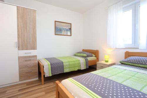Postel nebo postele na pokoji v ubytování Apartments by the sea Lumbarda, Korcula - 4393