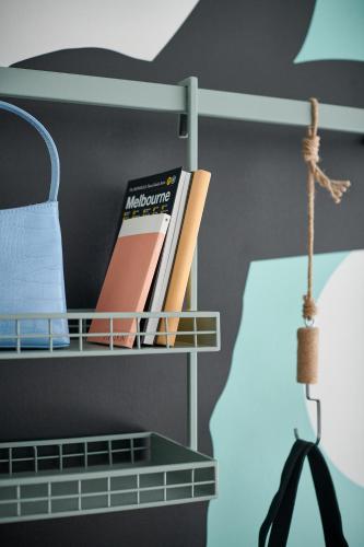 a shelf with books on it next to a lamp at lyf Collingwood Melbourne in Melbourne