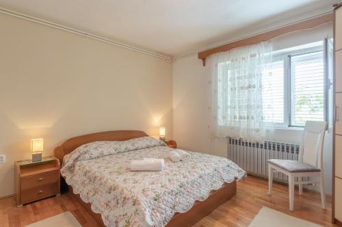 a bedroom with a bed and a window at Family friendly seaside apartments Orebic, Peljesac - 4537 in Orebić