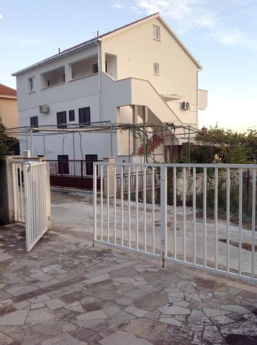 a white fence in front of a white house at Apartments by the sea Orebic, Peljesac - 4563 in Orebić