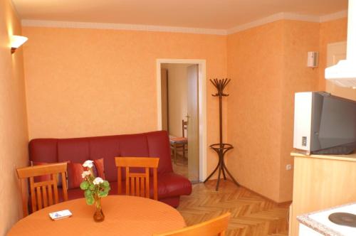 a living room with a table and a couch at Apartments by the sea Trstenik, Peljesac - 4511 in Trstenik