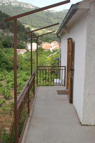 a balcony of a house with a view of a mountain at Apartments by the sea Trstenik, Peljesac - 4512 in Trstenik