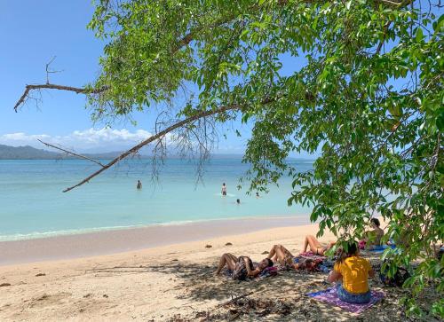 a group of people laying on the beach at Cabinas Tito in Cahuita