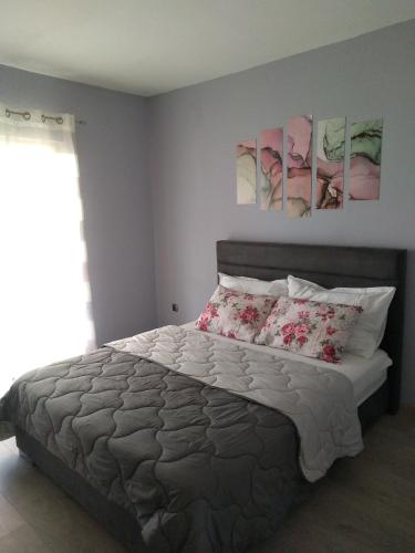 a bedroom with a bed with two paintings on the wall at Apartments by the sea Brna, Korcula - 4425 in Smokvica