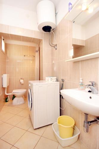 a bathroom with a sink and a toilet at Apartments by the sea Kneza, Korcula - 4365 in Pupnat