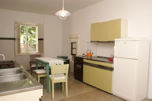 a kitchen with a white refrigerator and a table at Apartments by the sea Korcula - 4450 in Korčula