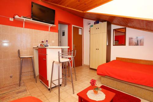 a small room with a bed and a kitchen with a counter at Apartment Racisce 4360a in Račišće