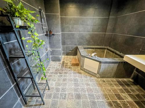 a bathroom with a shower with a bath tub at Woods Inn in Jiaoxi