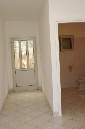 a bathroom with a door and a toilet at Apartment Grscica 4487a in Prizba