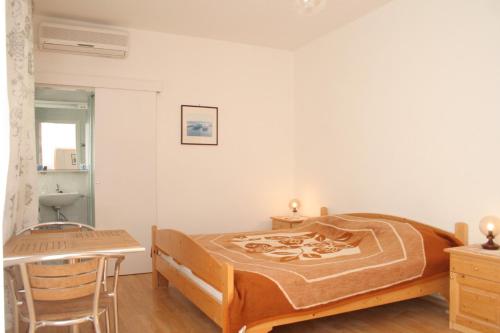 a bedroom with a bed and a table and a chair at Double Room Korcula 4356c in Korčula