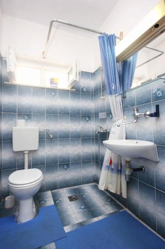 a bathroom with a toilet and a sink at Apartments by the sea Lumbarda, Korcula - 4440 in Lumbarda