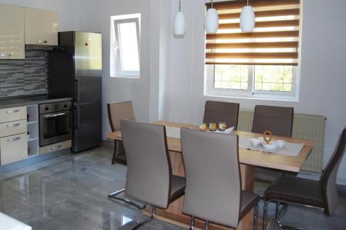 a kitchen and dining room with a wooden table and chairs at Apartments with a parking space Zavalatica, Korcula - 4420 in Zavalatica