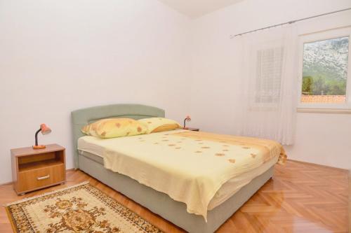 een slaapkamer met een bed, een tafel en een raam bij Apartments with a parking space Orebic, Peljesac - 4504 in Orebić