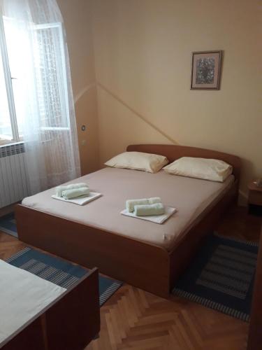 a bedroom with a bed with two towels on it at Apartments by the sea Orebic, Peljesac - 4509 in Orebić