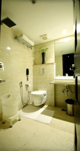 a bathroom with a toilet and a sink at Hotel The Prime Balaji Deluxe, City Centre, With Free Airport Pickup in New Delhi