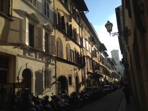 an alley with buildings and bikes parked on a street at Florence Art Apartments in Florence