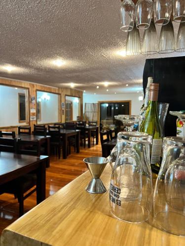a table with bottles of wine on top of it at Hotel Boutique Family Suites in Panguipulli