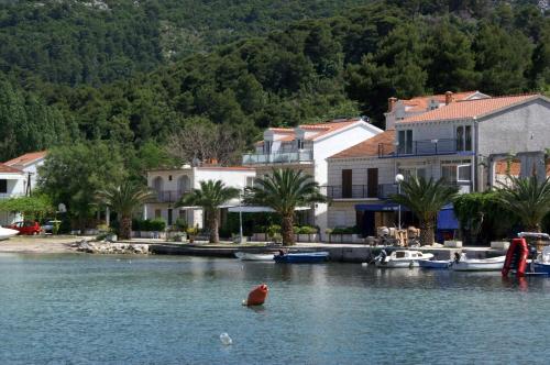 a group of houses and boats on a river at Apartments by the sea Zuljana, Peljesac - 4577 in Žuljana