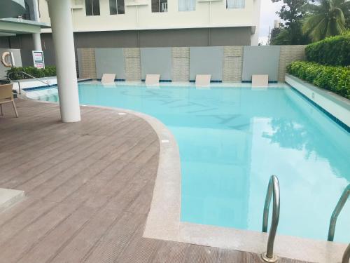 a large blue swimming pool in a building at One Spatial Iloilo Two Bedroom Condominium Unit with Pool and Gym in Iloilo City