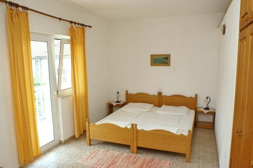 a bedroom with a bed and a window at Studio Zuljana 4576b in Žuljana