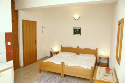a bedroom with a wooden bed in a room at Studio Zuljana 4576a in Žuljana