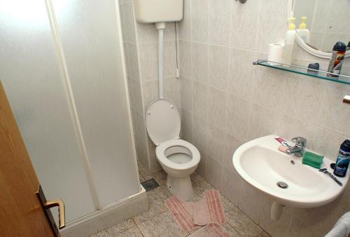 a bathroom with a toilet and a sink at Studio Zuljana 4576a in Žuljana