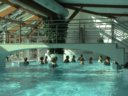 a group of people in a swimming pool at Hotel Astoria with private skibus in Janske Lazne