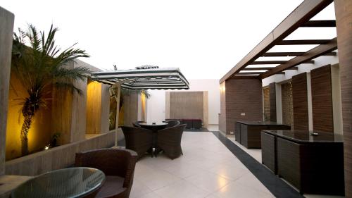 a restaurant with chairs and a table in a building at Hotel The Prime Balaji Deluxe, City Centre, With Free Airport Pickup in New Delhi