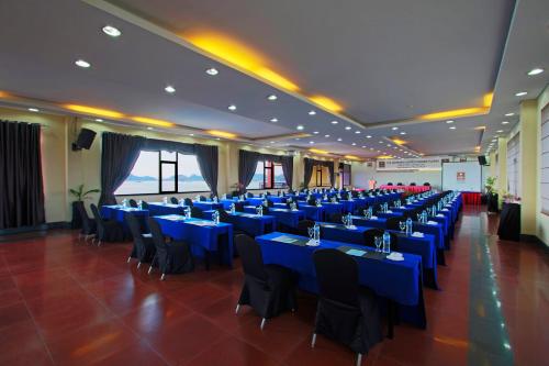 a large banquet hall with blue tables and chairs at The Jayakarta Suites Komodo Flores in Labuan Bajo
