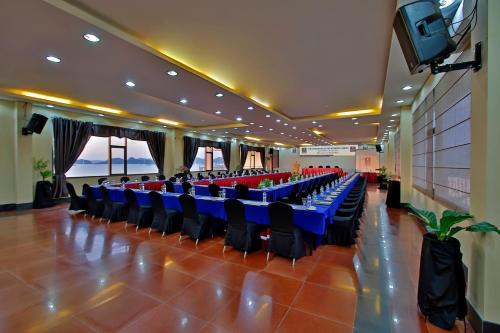 a large banquet hall with blue tables and chairs at The Jayakarta Suites Komodo Flores in Labuan Bajo