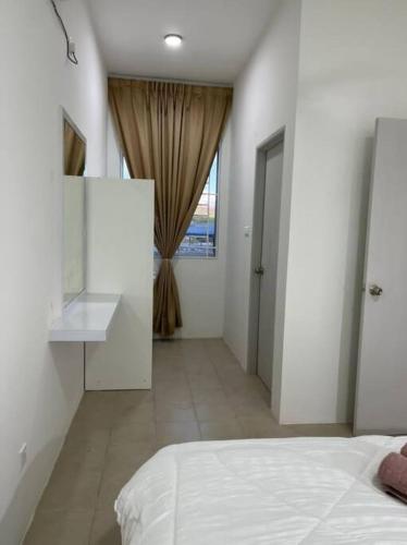 a white bedroom with a bed and a window at OrchidVilla Homestay at Southville Apartment in Kampong Parit