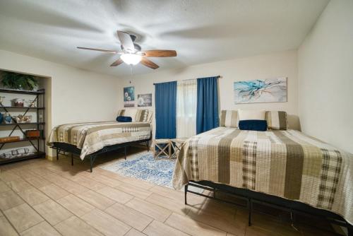 a bedroom with two beds and a ceiling fan at Large Tampa Home*Sleeps 16*Near Busch Gardens &USF in Tampa