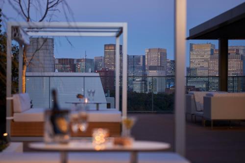 a balcony with a table and a view of the city at THE KITANO HOTEL TOKYO in Tokyo