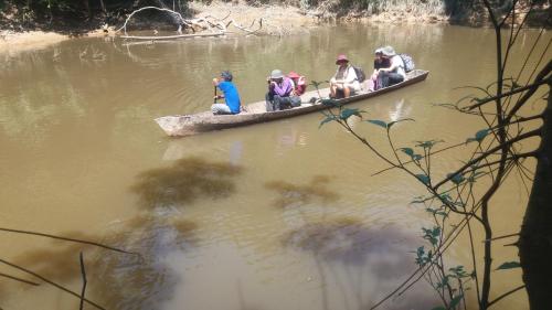 a group of people in a canoe on a river at Cabañas eco lógicas mu'ü in Loreto Mocagua