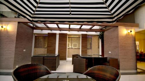 a room with a table and chairs and a ceiling at Hotel The Prime Balaji Deluxe, City Centre, With Free Airport Pickup in New Delhi