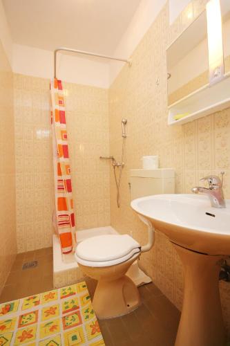a bathroom with a toilet and a sink at Apartments by the sea Orebic, Peljesac - 4525 in Orebić