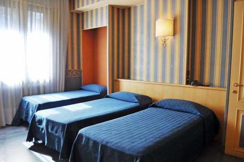 Cama ou camas em um quarto em Hotel Garda