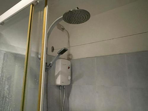 a shower in a bathroom with a shower head at Premiere Haven MOA Staycation in Manila