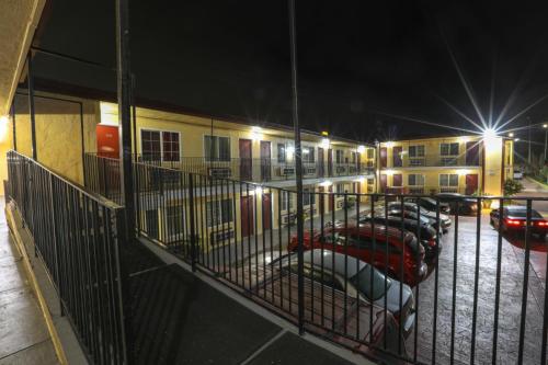 a row of cars parked in a parking lot at night at Motel 7 - Near Six Flags, Vallejo - Napa Valley in Vallejo