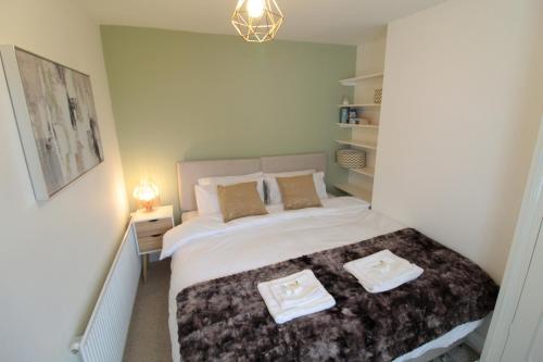 a bedroom with a bed with two pillows on it at Alma House by 360Stays - Private Garden, Free Parking, Close to Oxford City Centre with Parking in Oxford