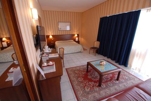 a hotel room with a bed and a table at Grand Hotel L'Approdo in Terracina