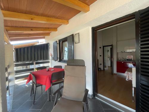 a dining room with a table and chairs on a balcony at Residence4a-Appartamento Rosso in Ravni