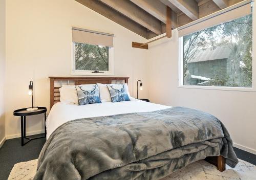 a bedroom with a large bed and a window at Crystal Brook Lodge in Dinner Plain