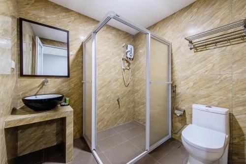 a bathroom with a shower and a toilet and a sink at Hako Hotel Taman U in Johor Bahru