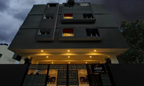 a tall building with a lit up front of it at UPAR Hotels Thoraipakkam, OMR in Chennai